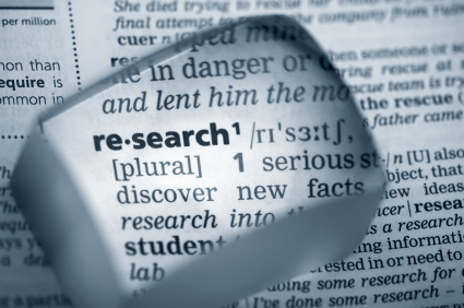 Magnifying glass highlighting the word "research"
